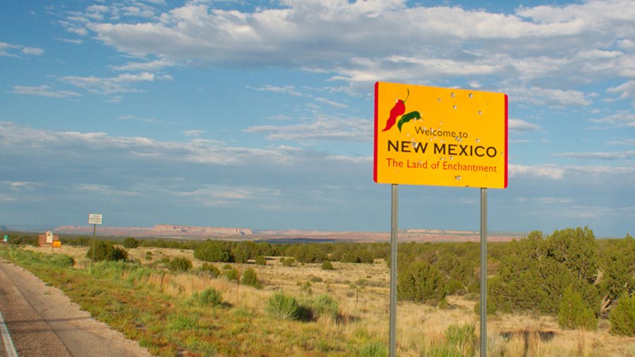 New Mexico tribe joins pushback on iGaming. Sign on deserted highway shows "Welcome to New Mexico"