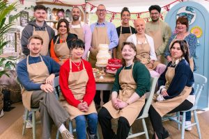 The possibilities of betting Bake Off SEASON 16 have been revealed. They smile around a table with a large decorative cake in the middle.