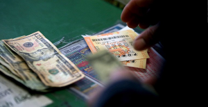 Image of cash and lottery tickets / The Cayuga Nation has won a key legal battle after a federal judge ruled that its lawsuit against New York State over gaming rights can move forward. 