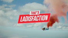 Clouds in the sky with 'That's Ladisfaction' in the center and a man skydiving below this.