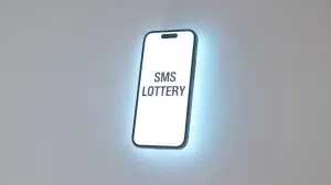 A photograph of a modern smartphone floating in the center of a stark white background. The phone's screen brightly illuminates, displaying a text message that reads "SMS LOTTERY" in bold black lettering. Norsk Tipping fined after massive lottery error misled 47,000 players