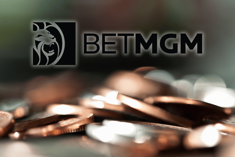 BetMGM raises profit outlook as it plans 0M shareholder payout. BetMGM logo on top of generic image of coins.
