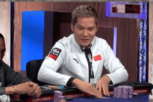Big-name pro Tony Lin apologizes for $5M WSOP real-time coaching scandal. Poker player wearing a white “Team China” jacket sits at a poker table with stacks of chips during a tournament game.