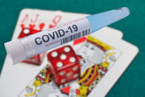 Coronavirus loan scammer sentenced for using money in gambling and cryptocurrencies. Test tube with COVID-19 written on it