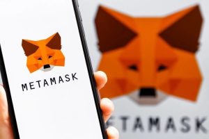 MetaMask is partnering up with Polymarket. MetaMask fox logo seen on smartphone and in background