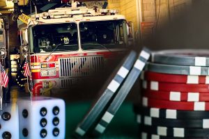 A New York man steals $450,000 from a volunteer fire company to fund gambling. A fire truck inside a station is mixed with gambling elements including poker chips and dice, symbolizing the theft of the fire company's gambling money.