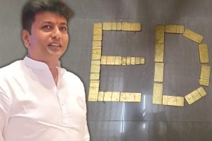 India's ED dismantles new $169 million gambling network linked to politician KC Veerendra. A man stands in front of a wall where gold bullion spells are arranged