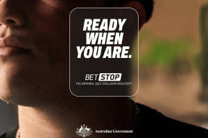 Australia’s self-exclusion register greatly improves wellbeing for most participants, ACMA reports. A close-up image showing the lower half of an anonymous person’s face beside a large BetStop graphic that reads “Ready when you are. BetStop — The National Self-Exclusion Register.” The Australian Government logo appears at the bottom.