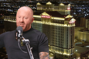 Caesars faces $7.8M fine in Nevada over ties to convicted bookmaker Mathew Bowyer. A bald man speaking into a studio microphone sits in the foreground, while a nighttime view of the illuminated Caesars Palace hotel and casino in Las Vegas fills the background.