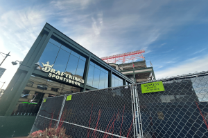 DraftKings to launch mobile sports wagering in Missouri. DraftKings branded building, with large windows. Outside the building is a fence.