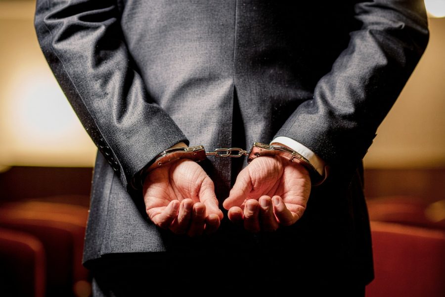 A man with handcuffs behind his back in a courtroom. South Korean police reports 5,196 arrests in yearlong cyber gambling probe