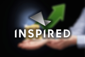 Inspired Entertainment reports strong Q3 2025 growth driven by digital expansion. Hands holding a small stack of coins with a large green upward arrow in the background and the Inspired Entertainment logo overlaid.