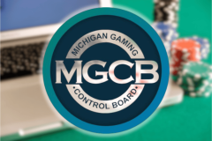 Michigan orders three online casinos to halt illegal operations immediately statewide. The Michigan regulator has now also issued cease and desist letters to 12 unlicensed offshore gambling operators. Logo of the Michigan Gaming Control Board displayed prominently in front of a blurred background showing a laptop and colorful casino chips.