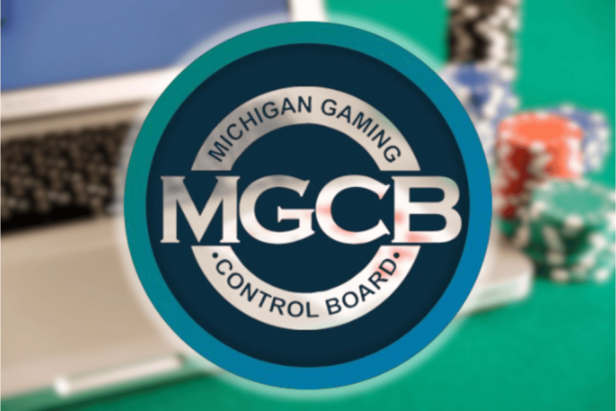 Michigan orders three online casinos to halt illegal operations immediately statewide. The Michigan regulator has now also issued cease and desist letters to 12 unlicensed offshore gambling operators. Logo of the Michigan Gaming Control Board displayed prominently in front of a blurred background showing a laptop and colorful casino chips.