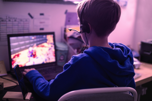 Norwegian study identifies link between computer gaming and increase in gambling among adolescents. Child gaming on laptop playing addictive online video game at home in his room.