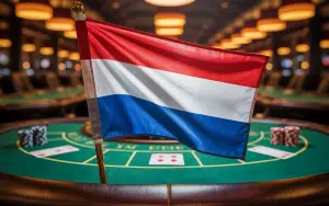 A photograph of the Netherlands flag prominently displayed in the foreground, of a casino. Dutch gambling authority issues notice to Tulipa Entertainment for violations