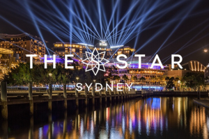 Star Entertainment logo on the top of an image of Star Entertainment building in Sydney at nighttime. Star Entertainment CFO and COO resign