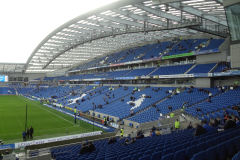 Brighton & Hove Albion football AMEX Stadium, green pitch on the left and chairs on the right-hand side. Soccer chairman Tony Bloom hit with betting allegations, but denies claims