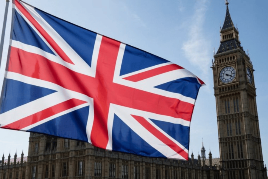A photograph of a vibrant Union Jack flag billowing proudly in front of the Houses of Parliament. BGC warns budget plans will mean thousands of job losses and illegal gambling set to double