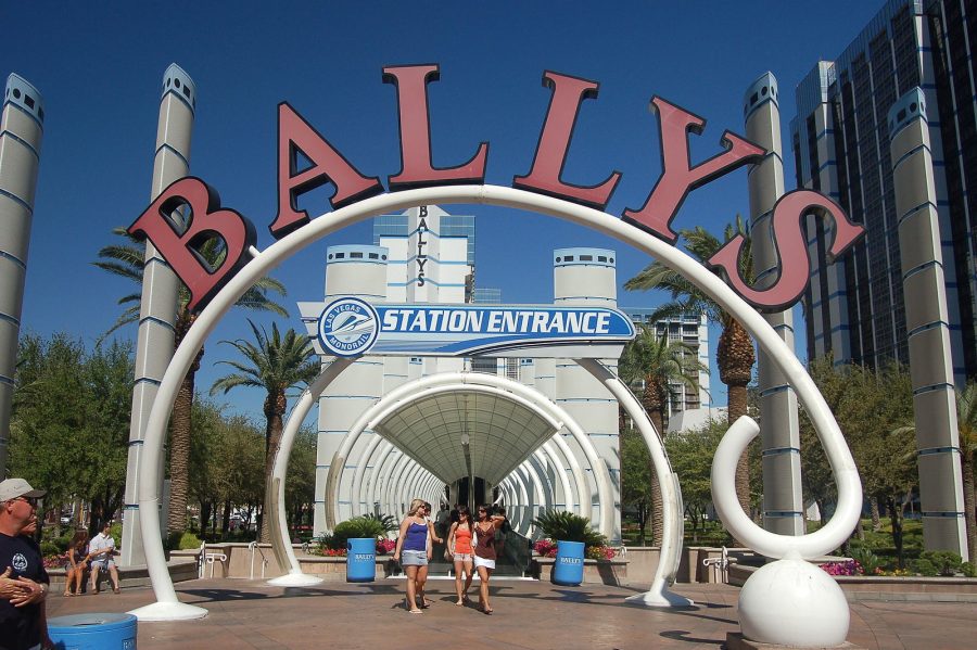 Bally's Monorail station entrance, big red lettering spelling out Ballly's. Clear blue skies.