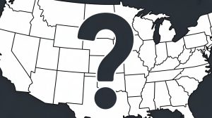 A close-up illustration of a simplified outline map of the United States rendered in clean black lines against a white background. The map shows the distinctive continental borders and coastlines without state divisions or geographic details, creating a minimalist silhouette. Positioned prominently in the center of the map is a large, bold question mark in deep charcoal gray, spanning roughly from the Great Plains to the eastern seaboard. The composition has a documentary or educational feel with crisp, high-contrast graphics that emphasize the uncertainty or unknown elements represented by the central question mark.