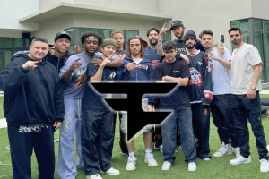 FaZe Clan faces uncertain future as creators exit after failed talks. A group of young men posing together outdoors in front of a modern building, wearing casual streetwear, with a large FaZe Clan logo overlaid in the center of the image.
