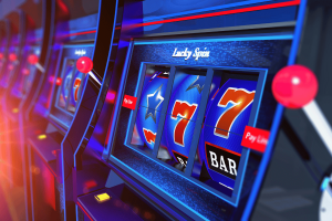 Pokies in over 670 NSW venues to be switched off after 4am. Row of brightly lit blue pokies machines with spinning reels showing sevens, stars and bar symbols inside a club gaming area.