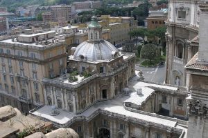 Rome, Vatican, Italy, Vatican buildings from the top of St. Peter's Basilica. Buildings in the background. Birds-eye view on a clear day.