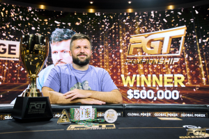 PGT Winner board in the background with Chad Eveslage sitting at the poker table in front smiling, wearing a light purple top. PGT 2025 season concludes, with Chad Eveslage taking home the win
