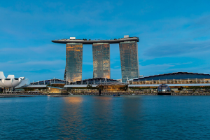 Blue sky at night, with the Marina Bay Sands hotel in the background. Las Vegas Sands saw an uptick in its Q4 financial report, but Sands China declined