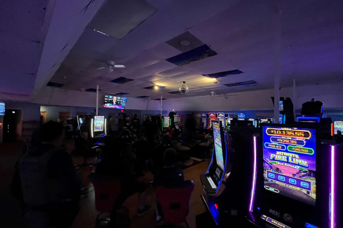 Dark room with gambling machines in the middle.