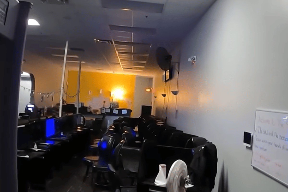 Florida Gambling Commission seizes over $157,000 and 231 illegal machines in raid. Interior of an illegal gambling room with rows of electronic gaming machines, chairs, and a fan, seized during a Florida Gaming Control Commission raid.