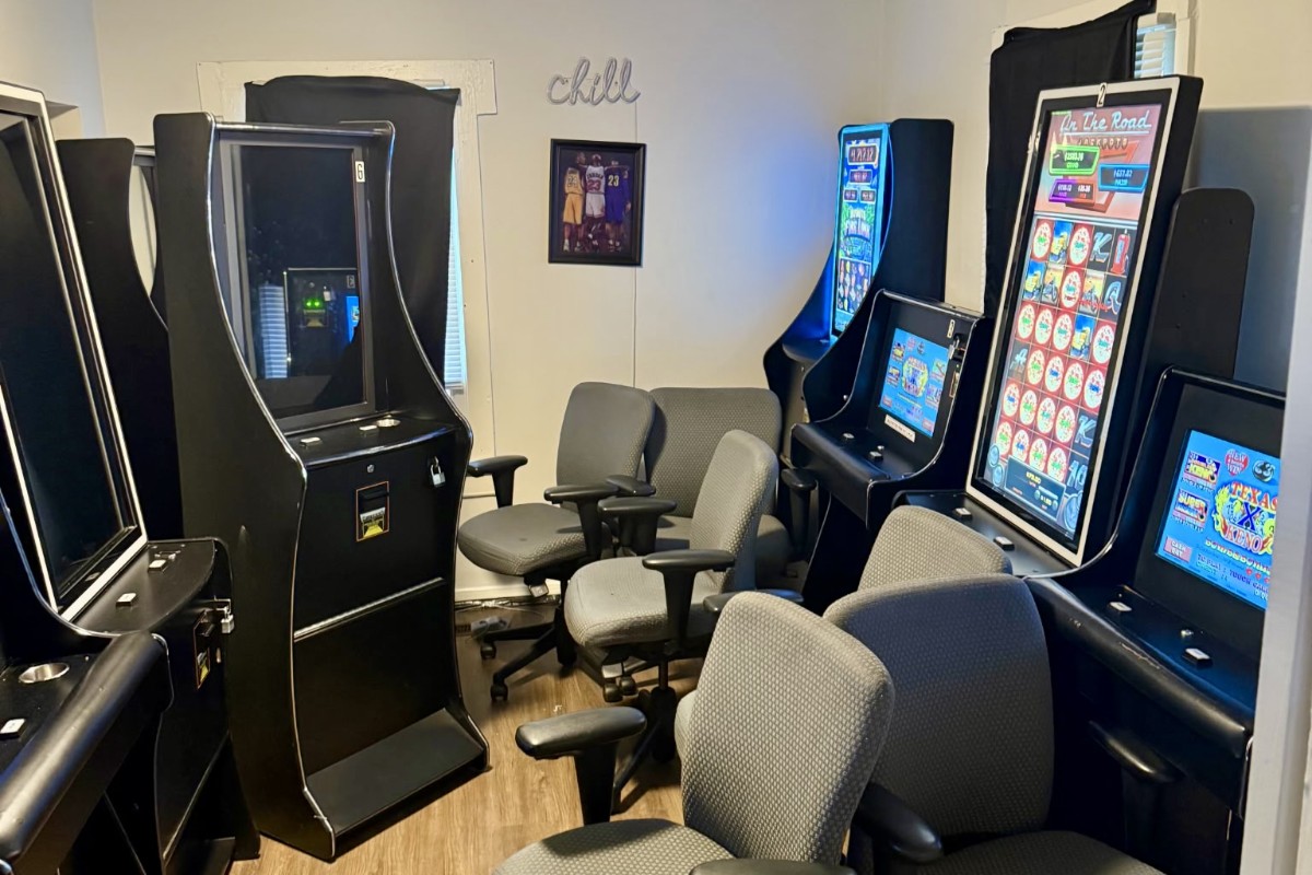 Illegal slot machines. Illegal slot machines lined up in a small room, with several electronic gaming cabinets and chairs seized during a Huntsville Police Department investigation.