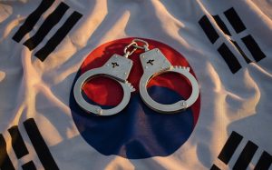 A pair of handcuffs on a South Korean flag. Judge allows Hafa Adai Bingo case defendant to travel to South Korea