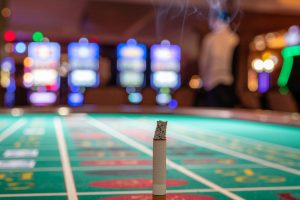 A cigarette on a casino table. New Jersey casino workers get a second chance to curb harmful smoking