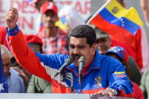 Nicolas Maduro in a blue, red and white shirt, speaking to a crowd behind a podium. Polymarket Maduro's bet resulting in $400,000 withdrawal sparks concerns over insider trading