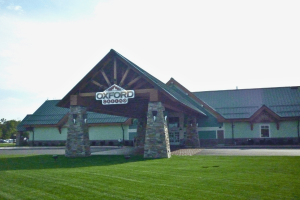 Oxford Casino takes Maine to court over allowing tribes to operate iGaming. Exterior view of Oxford Casino in Maine, showing the main entrance with stone pillars, peaked roof, and Oxford Casino sign.