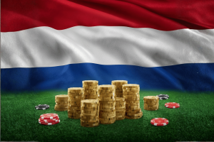 Dutch gambling regulator questions coalition plans on ads licenses. Stacks of gold coins and red and black poker chips on a green felt table, set against a large Netherlands flag in the background.