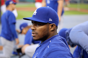Former MLB star Yasiel Puig found guilty in federal gambling investigation. Yasiel Puig in Los Angeles Dodgers cap and blue uniform sitting in the dugout during a game or practice.