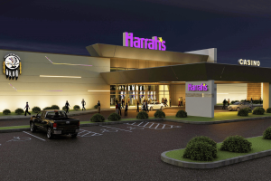 Harrah’s Oklahoma sets April grand opening date with Caesars despite Q4 losses. Harrah’s casino entrance at night with purple illuminated signage, glass doors, parked cars, and visitors crossing a lit driveway and accessible parking.
