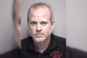 Booking photo of Christopher Armacost shown in a recent arrests graphic listing a charge of engaging in organized criminal activity, felony. Hitchcock Mayor arrested after sweeping gambling investigation targets City Hall operations