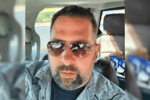 Lexington man gets prison time in federal COVID-19 loan gambling fraud scheme. Bearded man in sunglasses sits in a car