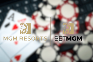 MGM Resorts and BetMGM expand responsible gaming investment nationwide this spring. MGM Resorts and BetMGM logos displayed side by side over a blurred background of poker chips and playing cards, including an ace of spades, representing casino and online gaming.