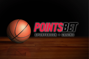 PointsBet Canada appeals Ontario regulator over five-day suspension tied to NBA. A basketball resting on a polished wooden court beside the PointsBet Sportsbook and Casino logo against a dark background.