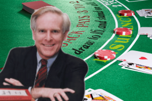 Gambling law expert explains California’s crackdown on ‘complicated’ blackjack-style games in cardrooms. Gambling law expert I. Nelson Rose pictured in front of a blackjack-style card table with playing cards and casino chips.