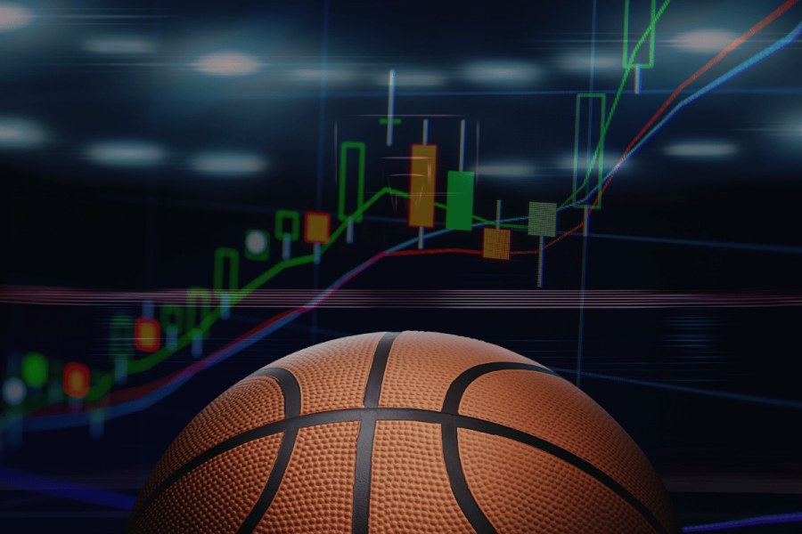Prediction market ads surge as March Madness betting hits record levels. A basketball in the foreground with a glowing financial chart in the background showing rising candlesticks and upward trend lines, symbolizing the growth of sports betting markets around basketball events.