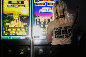A Flagler County Sheriff's Office crime scene technician took photos of illuminated slot-style gaming machines displaying bright graphics and jackpot amounts. Undercover gambling rackets are cashing in on Flagler County businesses