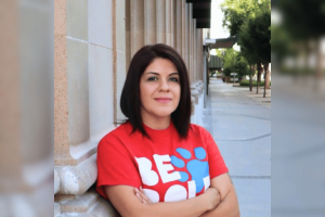 Fresno Arts Council ex manager admits $1.8M theft on gambling expenses. Suliana Caldwell in a red t-shirt against a building