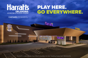 Harrah’s Oklahoma casino exterior in Chandler at night with illuminated signage, Caesars Rewards branding, modern architecture, and Route 66 location promotion