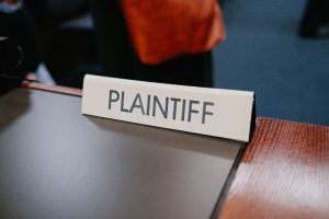 A sign that says Plaintiff on a courtroom desk.